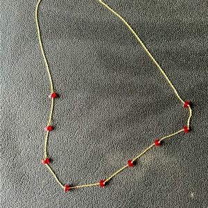 Gold necklace with red beading